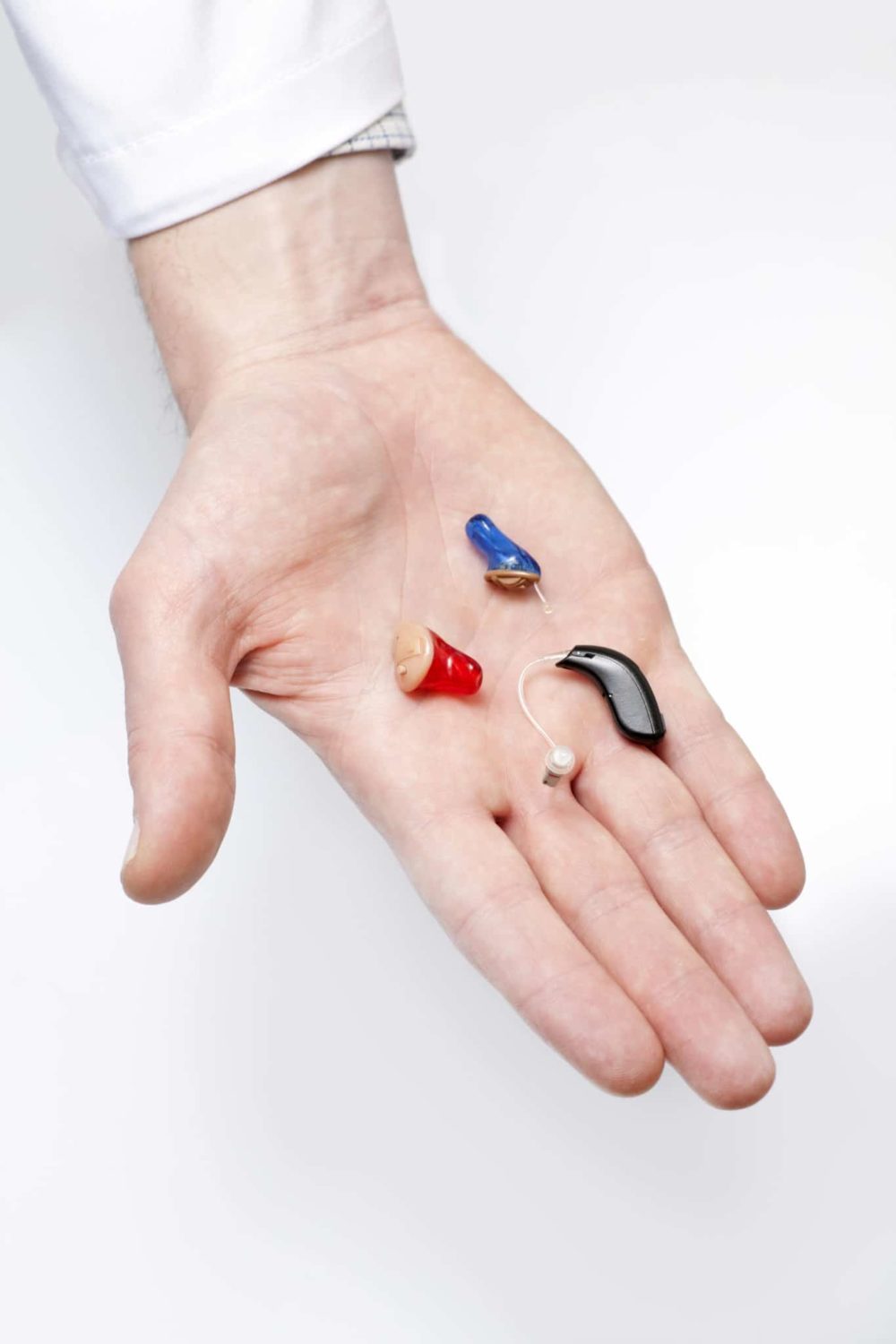 image of a hand holding hearing aids and hearing protection in New Jersey. 