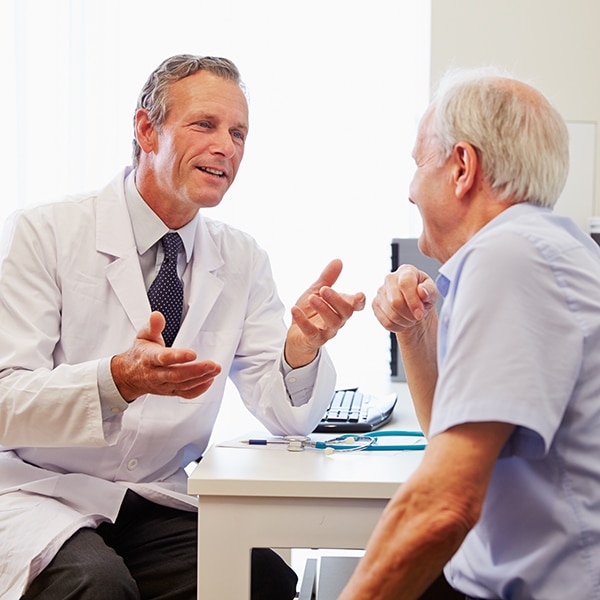 An audiologist in New Jersey going over hearing health options with an older patient. 