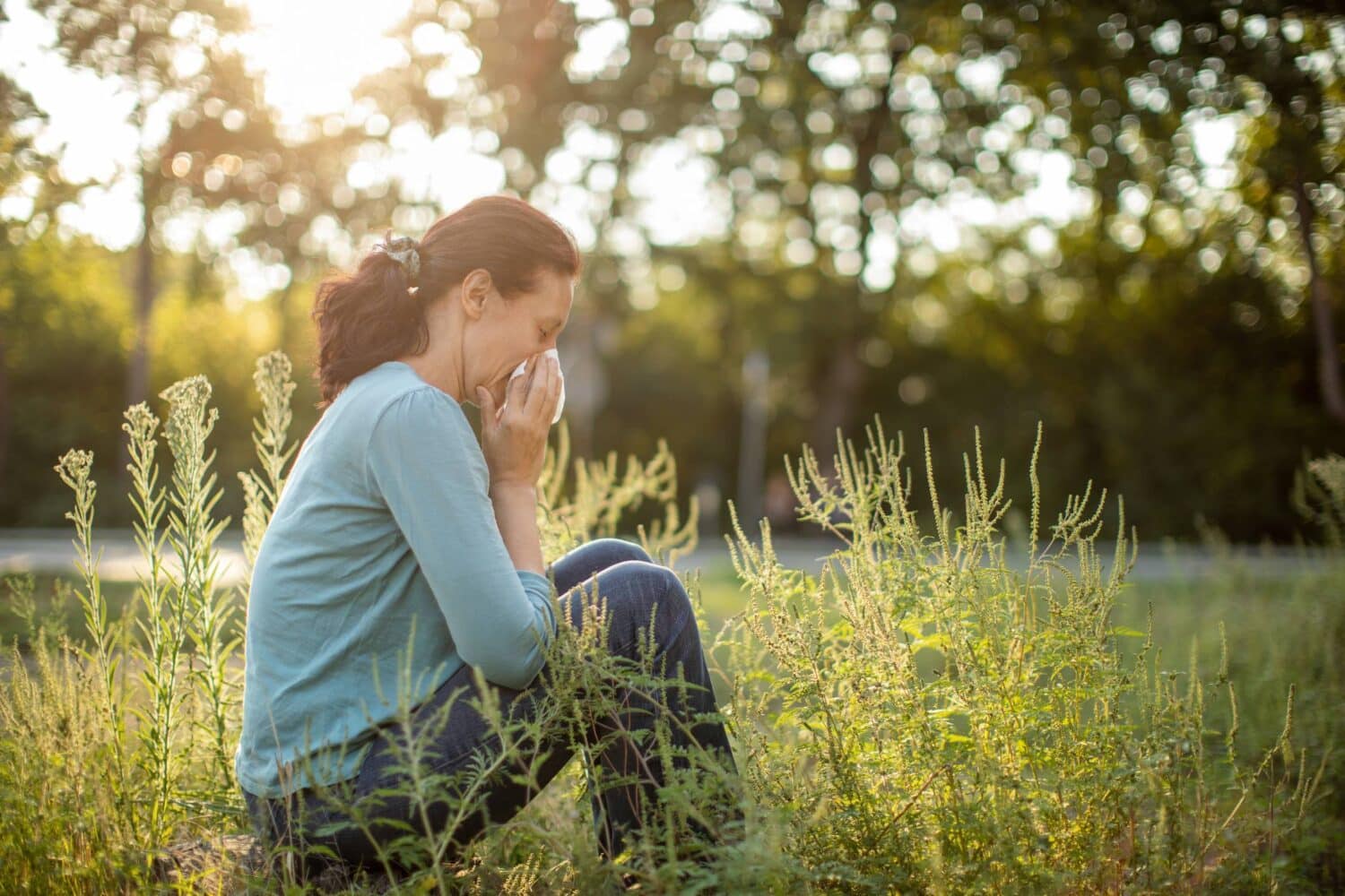 In a New Jersey park, a woman is suffering from allergies that are causing minor hearing loss.